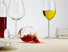 A glass of red wine falling over