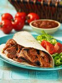 Tortilla with beef, tomato salsa and vegetables