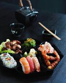 Japanese food on a black plate