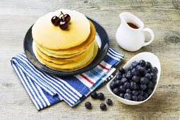 A stack of pancakes with fresh blueberries