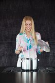 A woman stirring a pot on a stove