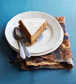 A slice of carrot cake with cream cheese frosting