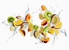 Various different fruits with a splash of water