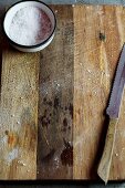 Sea salt and a knife on a wooden board