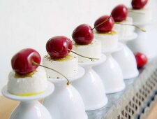 Goat's cream cheese with cherries on upturned egg cups