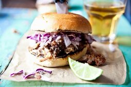 A pulled pork slider with red cabbage and apple