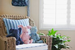 Soft toys on wicker armchair; California; USA