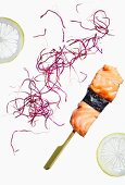 Salmon skewers with nori, red cabbage and lemon slices