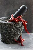 Dried chilli peppers in a mortar