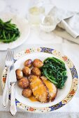 Roast piglet with potatoes and spinach