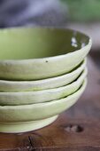 Stack of four green-glazed clay dishes