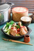 Spicy braised chicken with ginger and soy sauce served with bok choy and rice