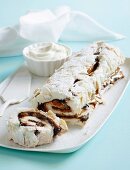 Meringue roll filled with chocolate and caramel sauce