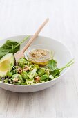 Spinach salad with courgettes, broad beans, avocado, walnuts and an olive and lime dressing