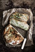 Rustic herb bread on a piece of paper