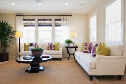 Lit floor lamps and seating in spacious living room; Azusa; California; USA