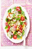 Courgette salad with cherry tomatoes, red onions, chilli peppers, basil and mint