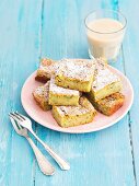 Slices of courgette cake with cinnamon icing sugar