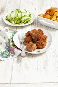Meatballs served with a courgette salad and roast potatoes