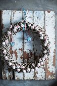 Festive wreath decorated with miniature meringues on wall