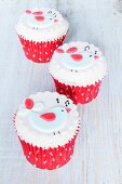 Raspberry and chocolate cupcakes decorated with singing birds