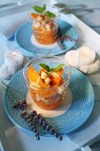 Vin Santo peaches with roasted flaked almonds, biscuit and mint leaves