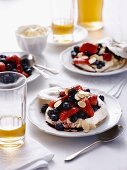 Pavlovas with berries and flaked almonds