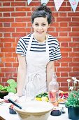 A young woman preparing food at garden party