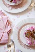 Pink cherry blossoms decorating a place setting on a wedding reception table