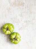 Two green stripped tomatoes