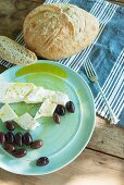Sheep's cheese and black olives with olive oil and country bread