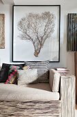 Framed coral fan above sofa in modern natural style