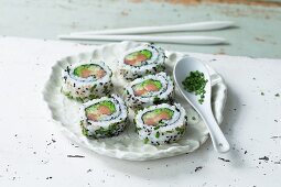 Uramaki sushi with green fish roe and fish