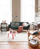 Red coffee table, various seating, mobile mini-bar and piano in front of floor-to-ceiling windows in living room