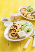 Pancake rolls with salmon, spinach and goat's cheese served with cucumber strips
