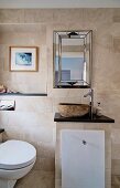 Masonry washstand with stone basin and toilet in elegant bathroom with sandstone tiles