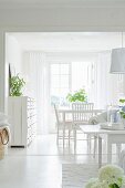 White dining area with vintage chest of drawers