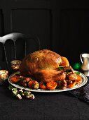 Festive roast turkey with a herb and pistachio stuffing and side dishes
