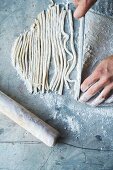 Homemade tagliatelle being cut