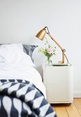 Retro table lamp on bedside cabinet with castors