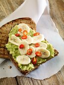 Grilled bread topped with avocado, bananas and chillis
