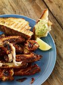 Grilled chicken wings with bread and an avocado dip