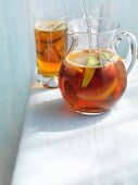 Pimms in a glass jug and in a glass