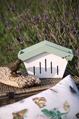 Butterfly box, bird ornament and picnic basket outdoors