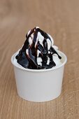 Frozen yoghurt with dark chocolate sauce