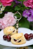 Scones with cherries on a cake stand
