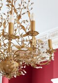 Chandelier with stylised leaves and classic candle-shaped bulbs