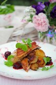 Roast pheasant with bacon, blackberry sauce and pea leaves