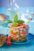 White beans with salmon and basil in a jar