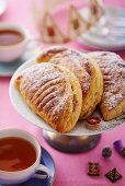 Three apple turnovers with icing sugar